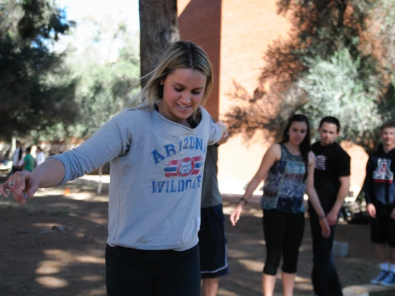 A person concentrating while trying to balance on an obstacle course.