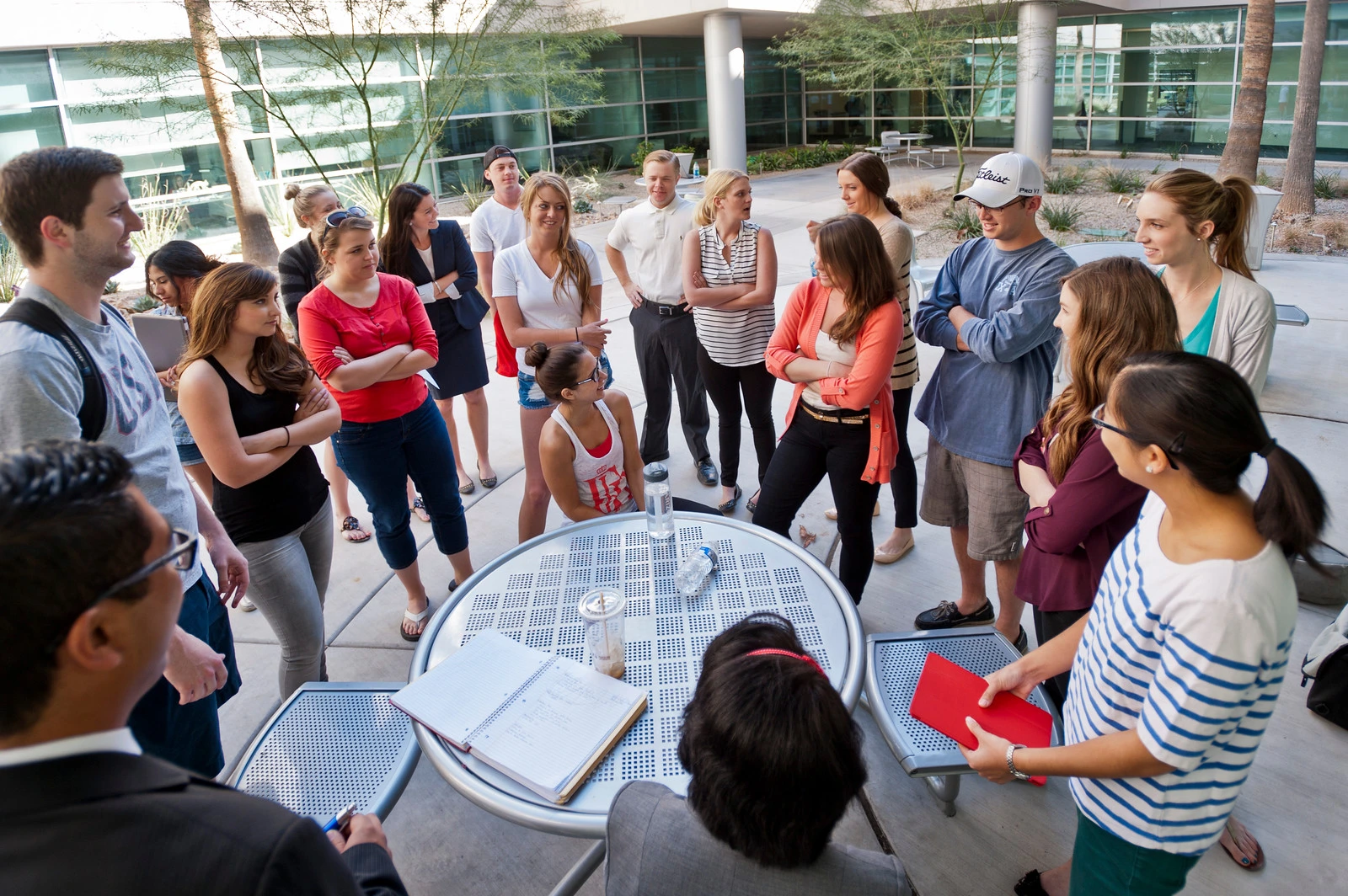 A group of people standing around talking.